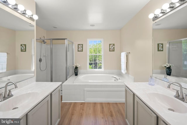13423 Fairland Park Dr, Silver Spring, MD 20904 - full bathroom with wood finished floors, a sink, a bath, and a stall shower