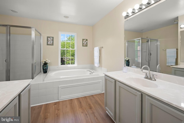 13423 Fairland Park Dr, Silver Spring, MD 20904 - bathroom featuring vanity, wood finished floors, a garden tub, and a stall shower