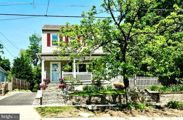 view of front of property with fence and a porch
