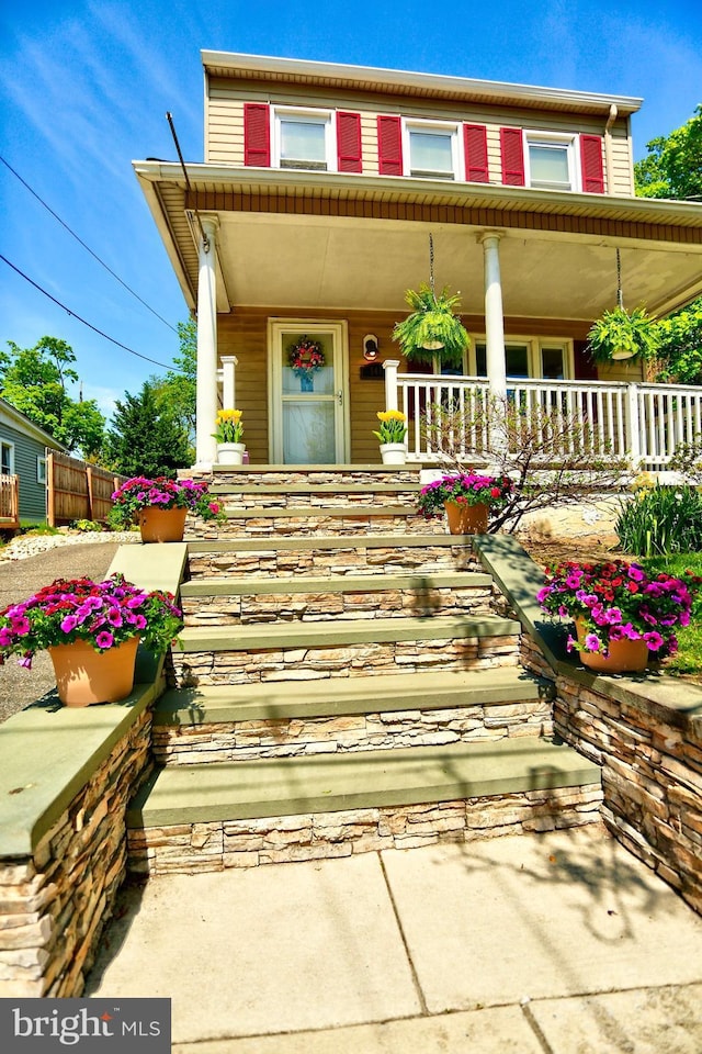 view of exterior entry featuring a porch