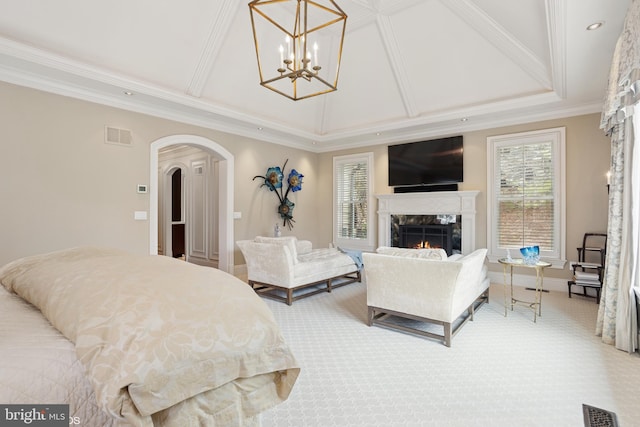 carpeted bedroom featuring crown molding, visible vents, a high end fireplace, arched walkways, and a notable chandelier
