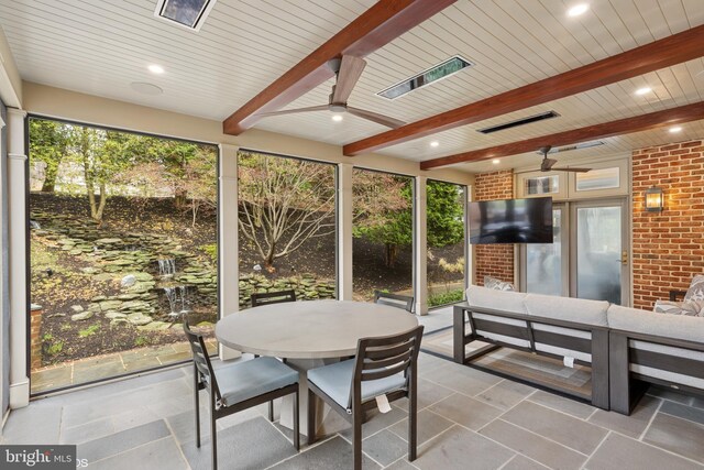sunroom featuring ceiling fan, an outdoor hangout area, and outdoor dining area