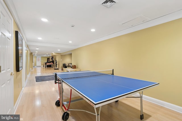 recreation room with light wood finished floors, visible vents, and baseboards