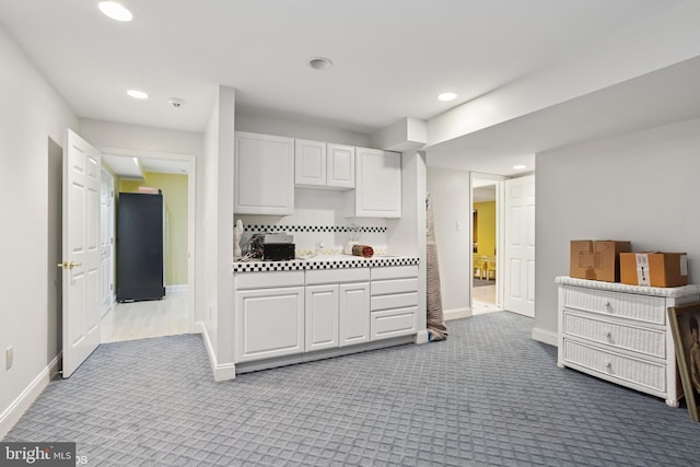 kitchen featuring white cabinetry, baseboards, recessed lighting, and carpet floors