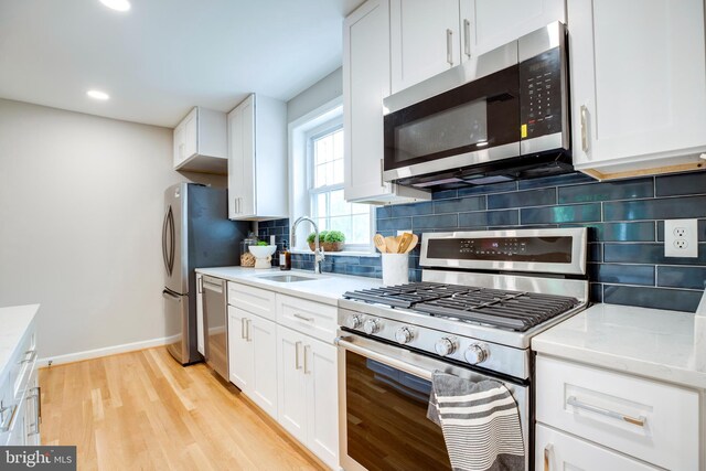 3306 Landover St, Alexandria, VA 22305 - kitchen with stainless steel appliances, a sink, white cabinetry, and recessed lighting