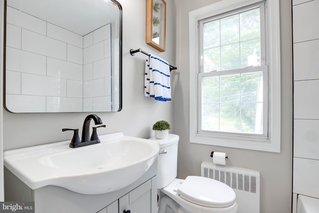 3306 Landover St, Alexandria, VA 22305 - bathroom with radiator heating unit, plenty of natural light, vanity, and toilet