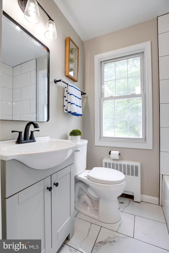 3306 Landover St, Alexandria, VA 22305 - bathroom with radiator, toilet, vanity, marble finish floors, and a bath