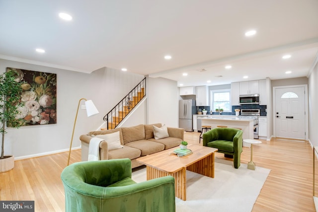 3306 Landover St, Alexandria, VA 22305 - living area featuring stairs, light wood-style floors, baseboards, recessed lighting, and ornamental molding