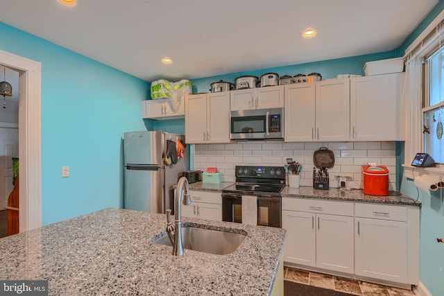 2744 Pelham Ave, Baltimore, MD 21213 - kitchen featuring stainless steel appliances, tasteful backsplash, light stone counters, recessed lighting, and white cabinets