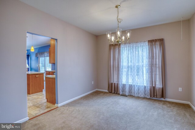 unfurnished room with light carpet, baseboards, and an inviting chandelier