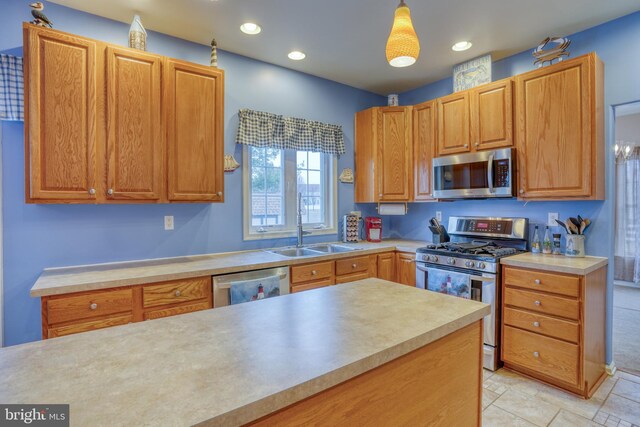 kitchen with light countertops, appliances with stainless steel finishes, recessed lighting, and a sink