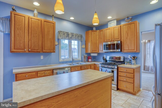 kitchen featuring recessed lighting, hanging light fixtures, stainless steel appliances, light countertops, and a sink