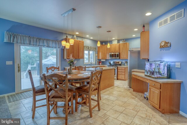 dining room with baseboards, visible vents, stone finish flooring, and recessed lighting