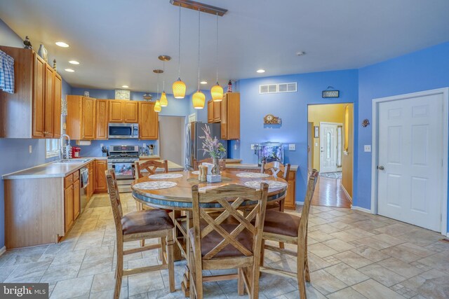 dining room with stone tile floors, visible vents, recessed lighting, and baseboards