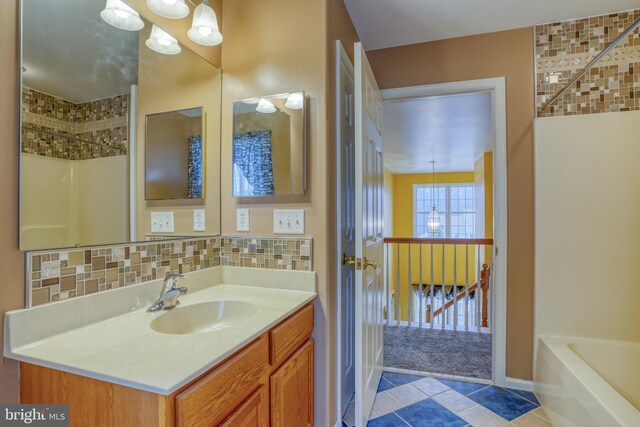 full bath with tile patterned floors, vanity, and decorative backsplash