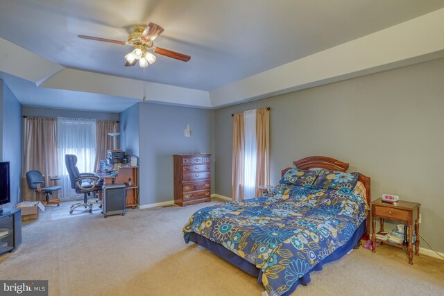 carpeted bedroom featuring a ceiling fan and baseboards