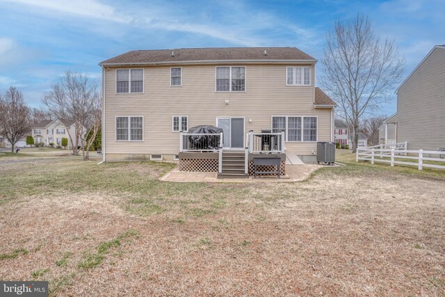 rear view of property with fence, cooling unit, a lawn, and a wooden deck