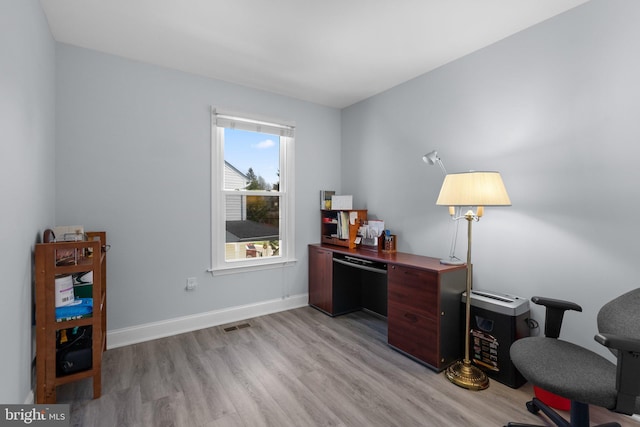 office space featuring baseboards and light wood-type flooring
