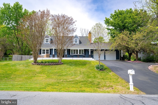 cape cod house featuring a front yard, covered porch, aphalt driveway, an attached garage, and fence