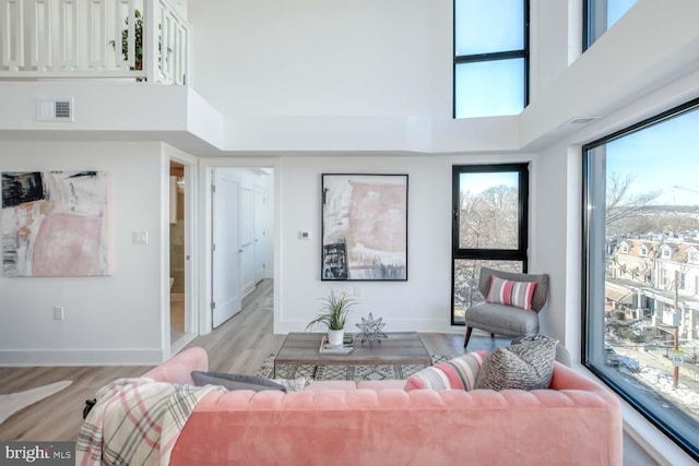 4328 Georgia Ave NW Unit 401, Washington, DC 20011 - living room with light wood-style floors, a high ceiling, baseboards, and visible vents
