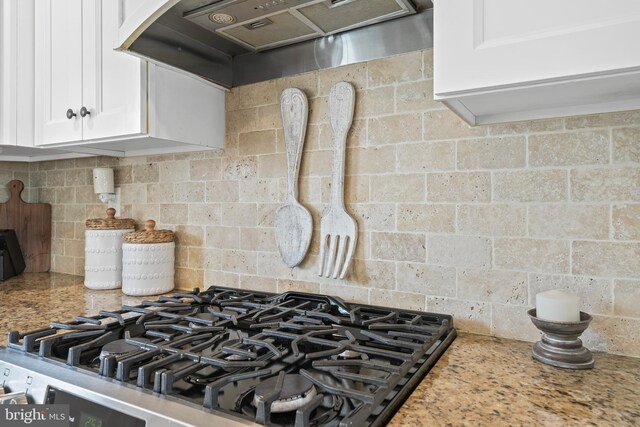 16 Century Way, Hamilton, NJ 08690 - kitchen featuring light stone counters, decorative backsplash, wall chimney range hood, white cabinetry, and stovetop