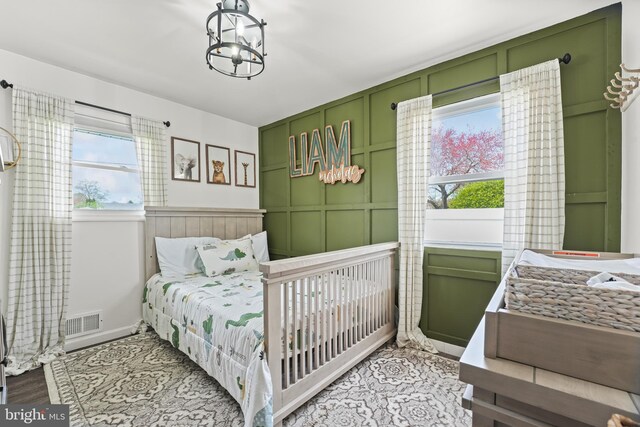 16 Century Way, Hamilton, NJ 08690 - bedroom featuring visible vents, wood finished floors, an inviting chandelier, and a decorative wall