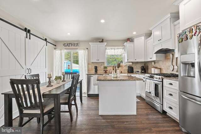 16 Century Way, Hamilton, NJ 08690 - kitchen featuring light stone counters, appliances with stainless steel finishes, a barn door, a center island, and backsplash