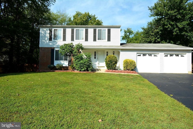 7112 Bonniemill Ln, Springfield, VA 22150 - view of front of property with a garage, asphalt driveway, a front lawn, brick siding, and a porch