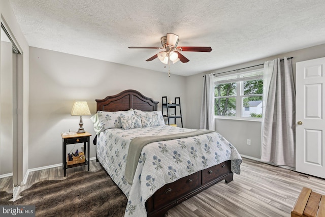 7112 Bonniemill Ln, Springfield, VA 22150 - bedroom featuring a textured ceiling, wood finished floors, baseboards, and a ceiling fan