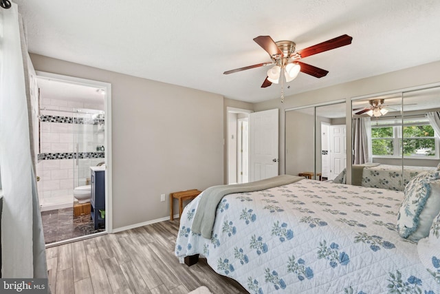 7112 Bonniemill Ln, Springfield, VA 22150 - bedroom with wood finished floors, two closets, baseboards, ensuite bath, and a ceiling fan