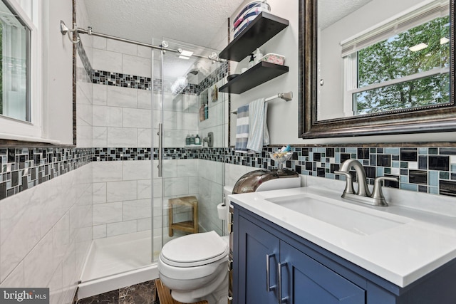 7112 Bonniemill Ln, Springfield, VA 22150 - bathroom featuring a textured ceiling, a stall shower, toilet, vanity, and tile walls