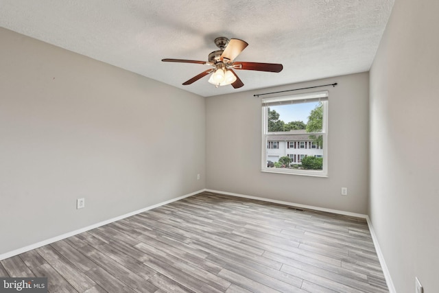 7112 Bonniemill Ln, Springfield, VA 22150 - unfurnished room featuring wood finished floors, a ceiling fan, a textured ceiling, and baseboards