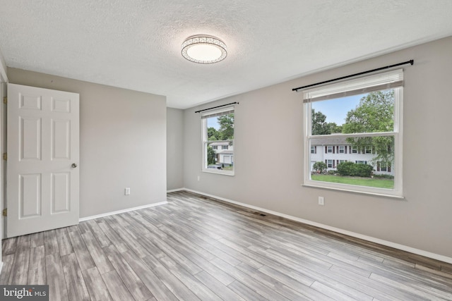 7112 Bonniemill Ln, Springfield, VA 22150 - spare room featuring wood finished floors, baseboards, and a textured ceiling