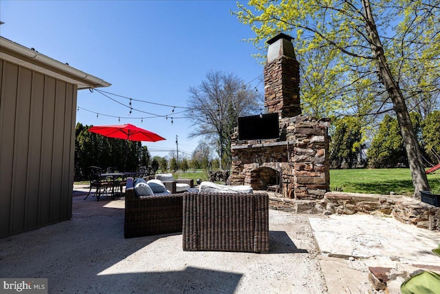 view of patio featuring an outdoor living space with a fireplace