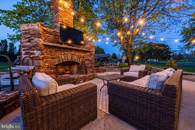 view of patio / terrace with an outdoor living space with a fireplace