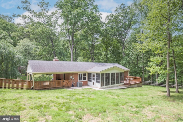 13709 Wendover Rd, Silver Spring, MD 20904 - rear view of property featuring a sunroom, a wooden deck, central air condition unit, a chimney, and roof with shingles