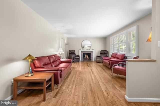 13709 Wendover Rd, Silver Spring, MD 20904 - living room featuring light wood-type flooring, a brick fireplace, and baseboards