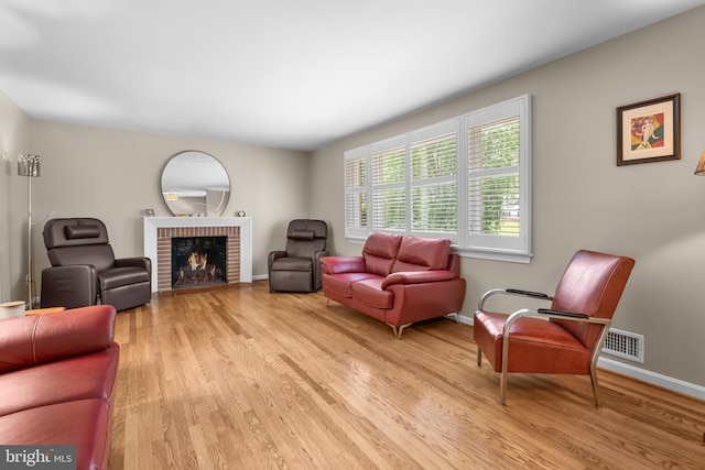 13709 Wendover Rd, Silver Spring, MD 20904 - living area with light wood-style flooring, a fireplace, and baseboards