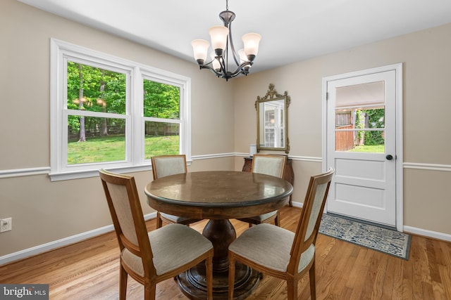 13709 Wendover Rd, Silver Spring, MD 20904 - dining room with a chandelier, plenty of natural light, light wood-style flooring, and baseboards