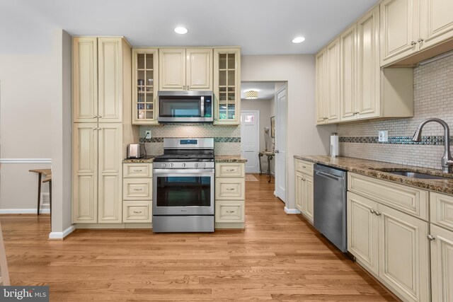 13709 Wendover Rd, Silver Spring, MD 20904 - kitchen featuring appliances with stainless steel finishes, cream cabinetry, a sink, backsplash, and recessed lighting
