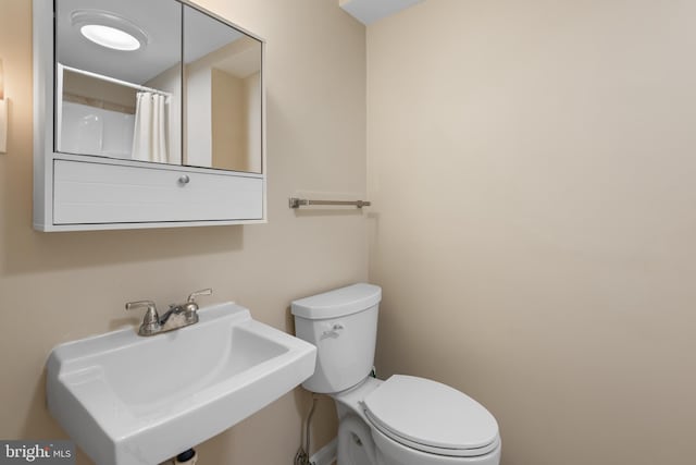 13709 Wendover Rd, Silver Spring, MD 20904 - bathroom with a sink, toilet, and a shower with curtain