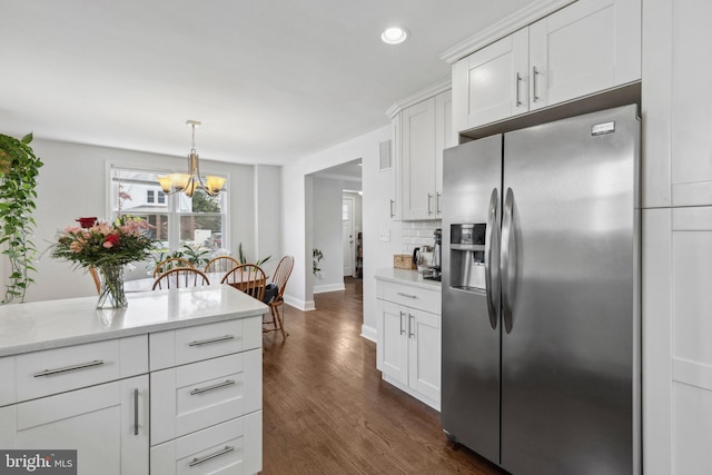 kitchen with stainless steel fridge with ice dispenser, a chandelier, light countertops, baseboards, and recessed lighting