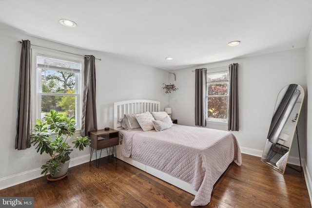 bedroom featuring multiple windows, baseboards, wood finished floors, and recessed lighting