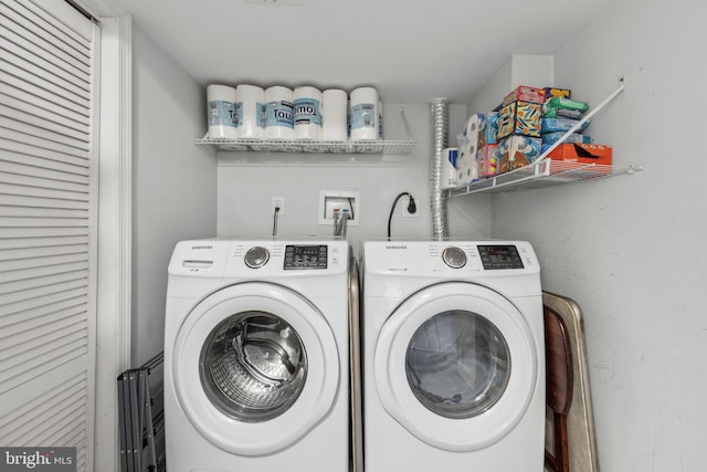 washroom with washing machine and clothes dryer