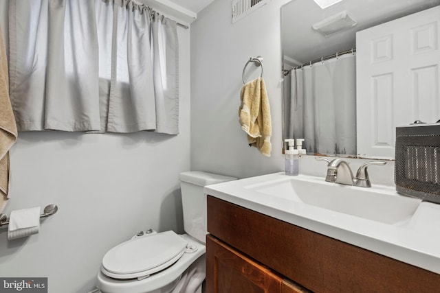 bathroom featuring toilet and vanity