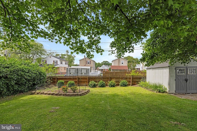 view of yard with an outdoor structure and a storage shed