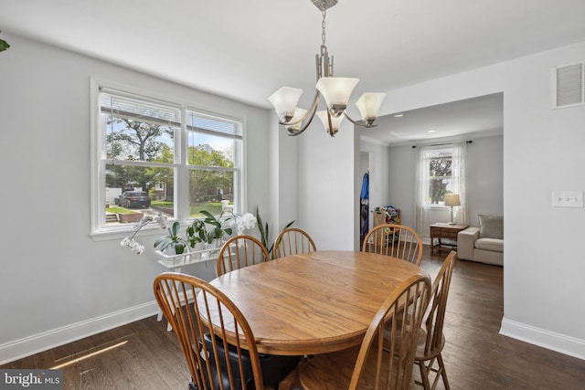 dining room featuring baseboards, a chandelier, and dark wood-style flooring