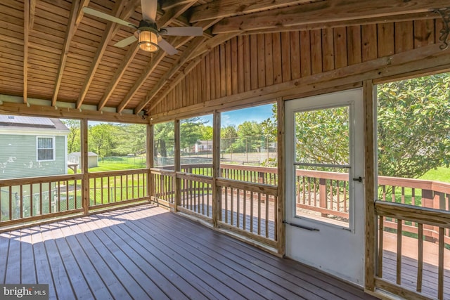 unfurnished sunroom featuring a wealth of natural light and a ceiling fan