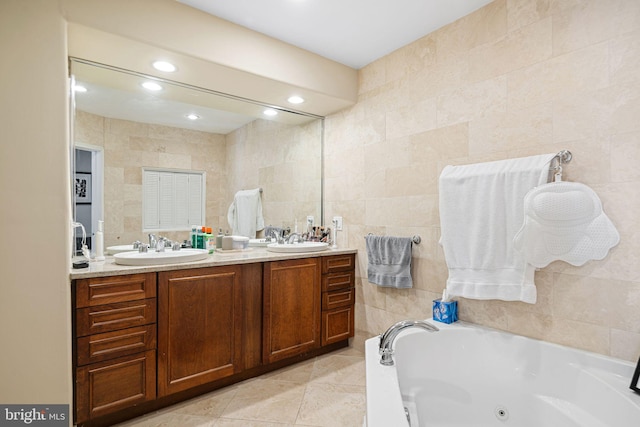 1207 Spruce St Unit 301, Philadelphia, PA 19107 - bathroom featuring tile walls, a tub with jets, double vanity, and a sink
