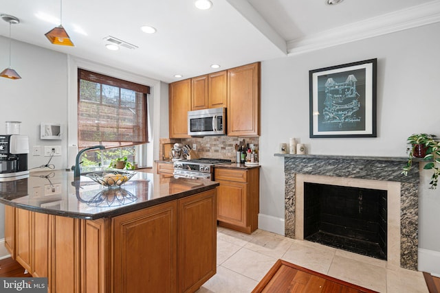 1207 Spruce St Unit 301, Philadelphia, PA 19107 - kitchen with tasteful backsplash, dark stone counters, stainless steel appliances, a sink, and visible vents